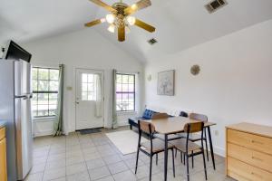 a kitchen with a ceiling fan and a table at Biloxi Resort Cottage with Pool and Lake Access! in Biloxi