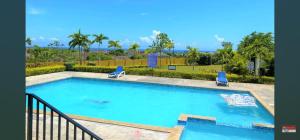a swimming pool with a view of the ocean at Stonebrook Manor Villa Chateau in Falmouth