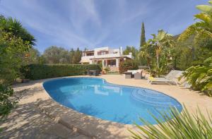 a swimming pool in front of a house at Can Juanito in Playa d'en Bossa