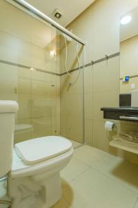 a bathroom with a toilet and a glass shower at BHomy Paulista Remodelado na Av Paulista BA204 in São Paulo