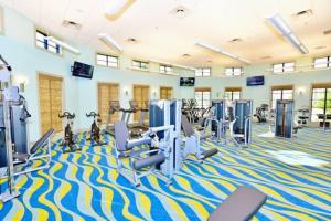 a gym with treadmills and cardio equipment in a room at 4BR Townhouse Private Pool BBQ Near Disney in Kissimmee