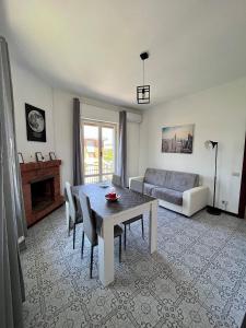 a living room with a table and a couch at Reversal apartment in Santa Marinella