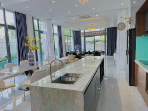 a kitchen with a counter and a living room at Private 5Brs Pool Villa Luxurious Furniture in Danang