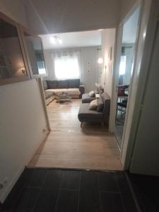 a view of a living room with a couch at Studio cosy à 10 minutes du centre-ville. in Saint-Étienne