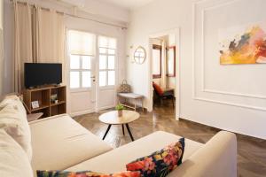 a living room with a couch and a tv at villa Chris in Pylos