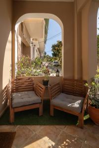 two chairs and a table on a patio at villa Chris in Pylos