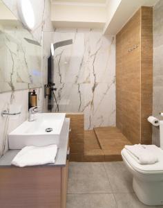 a bathroom with a sink and a toilet and a shower at villa Chris in Pylos