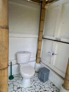 a bathroom with a toilet and a trash can at La Cometa - Palomino in Palomino