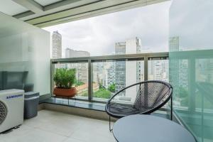 a balcony with a chair and a view of a city at BHomy República Moderno e desejado SE1305 in São Paulo