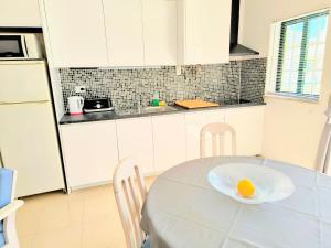 a kitchen with a table with an egg on a plate at DUNAS DO ALVOR by LTS Holidays - #127 in Alvor