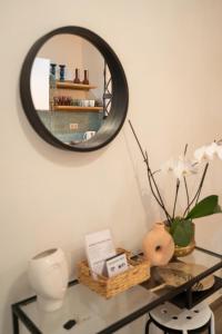 a mirror on a wall above a glass table at Maisonette Pylos in Pylos