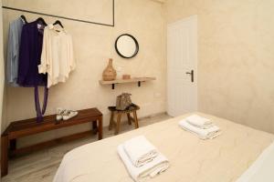 a bedroom with a bed and a table and a mirror at Maisonette Pylos in Pylos