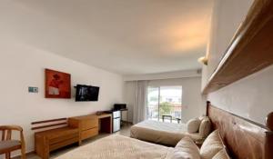 a bedroom with two beds and a television in it at Vacation getaway with beach access & balcony in Cancún