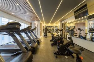 a gym with treadmills and elliptical machines at BHomy VMadalena - Com vista de Sampa UP310 in São Paulo