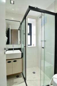 a bathroom with a glass shower and a sink at BHomy Perdizes - Piscina com vista de Sampa VA410 in Sao Paulo