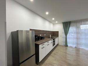 a kitchen with a stainless steel refrigerator in a room at Wohlfühloase Datteln-Hamm-Kanal in Hamm