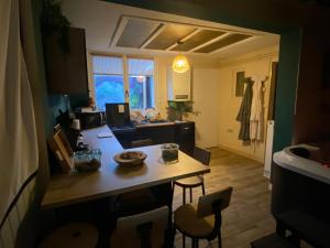 a kitchen and living room with a table and chairs at Nosy Komba Spa in Carvin