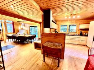 a kitchen and dining room with a piano in a cabin at Les Villas d' Onalou Port Blanc in Penvénan