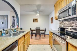 a kitchen with a sink and a table with chairs at WFH-Friendly Las Vegas Condo 2 Mi to Strip! in Las Vegas