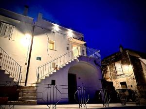 a white building with stairs and a light on it at Casa Vacanze Luxury BACIO DI LUNA in Montalbano Jonico