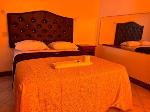 a hotel room with a bed with a yellow bedspread at Hospedaje San Blas in Lima