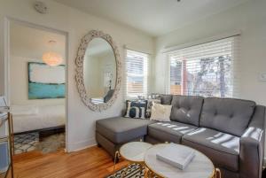 a living room with a couch and a mirror at Vintage Tiny House CUTE 1BDRM Big Appeal in Colorado Springs