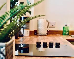 a kitchen counter with a coffee pot on a stove at *Luxury Apartment 2min from City in Carlisle