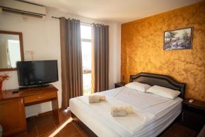 a bedroom with a bed with two towels on it at Villa Elezi in Ulcinj