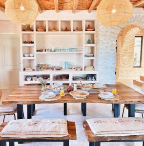 a dining room with a wooden table and chairs at Kaouki Lodge in Sidi Kaouki