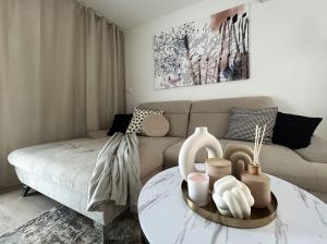 a living room with a couch and a table at Apartment Aria in Lovran +31 photos