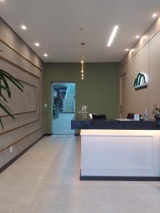 an office lobby with a white bench in the middle at Pousada Eco Da Montanha in Passa Quatro