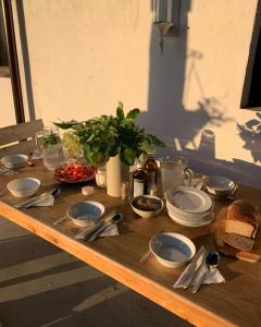 a wooden table with plates and utensils on it at Poganty - Jałownik in Giżycko