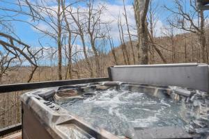a hot tub with water in it on a deck at Mountain View Manor in Banner Elk
