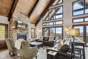 a living room with a stone fireplace and furniture at Mountain View Manor in Banner Elk