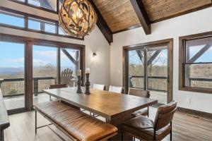a dining room with a table and chairs and windows at Mountain View Manor in Banner Elk +31 photos