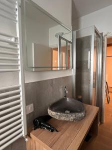a bathroom with a sink and a mirror at CHALET GIOVANNI in Aprica