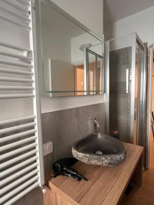 a bathroom with a sink and a mirror at CHALET GIOVANNI in Aprica