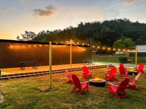 a group of red chairs and a fire pit at Wildflower Room At The Trailblazer Unit 10 in Townsend