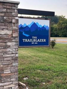 a sign for the trailblazer sign on a brick wall at Wildflower Room At The Trailblazer Unit 10 in Townsend