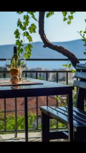 a table with a bottle of wine and two glasses at Apartment Kjara in Tivat