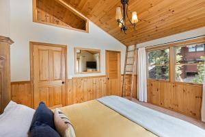 a bedroom with a bed and a wooden ceiling at Mineral Springs 3 BR w Hot tub Available in Alpine Meadows in Olympic Valley