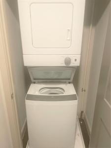 a white washer and dryer in a small bathroom at Bright Studio Downtown 98 Walk Score in Cincinnati