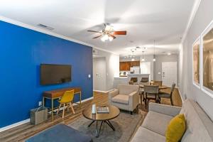 a living room with a couch and a dining room at Charming 1BD in Trendy West End Neighborhood in Dallas