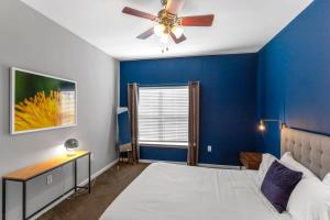 1 dormitorio con paredes azules y ventilador de techo en Charming 1BD in Trendy West End Neighborhood, en Dallas