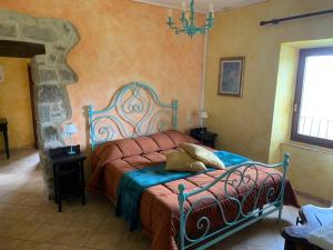 a bedroom with a bed and a chandelier at San Processo Agriturismo in Castel del Piano