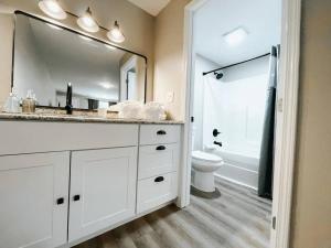 a bathroom with a sink and a toilet and a mirror at Wildflower Room At The Trailblazer Unit 9 in Townsend