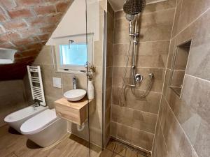 a bathroom with a shower and a toilet and a sink at AIR σϝ HOME Aραɾƚɱҽɳƚ in Novi Ligure +29 photos