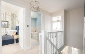 a white bedroom with a bed and a bathroom at Stunning stylish 3bed house in Reading city centre in Reading