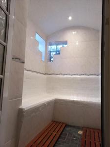 a bathroom with a bath tub with a window at Colorina Complejo Residencial in San Rafael