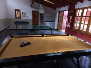 a ping pong table in a room with a pool table at Colorina Complejo Residencial in San Rafael